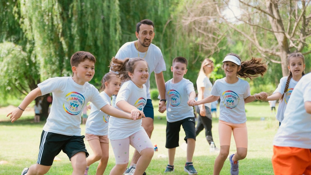 a group of young children playing a game of frisbee